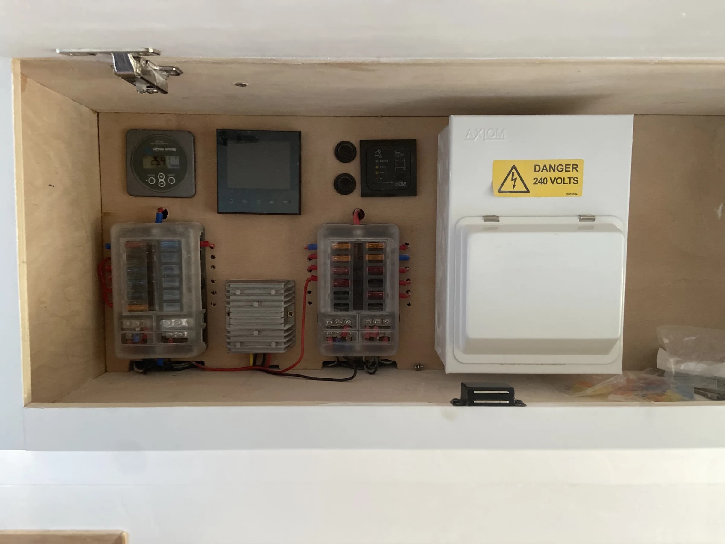 Labelled 12V and 230V distribution equipment inside the Roam Wired campervan