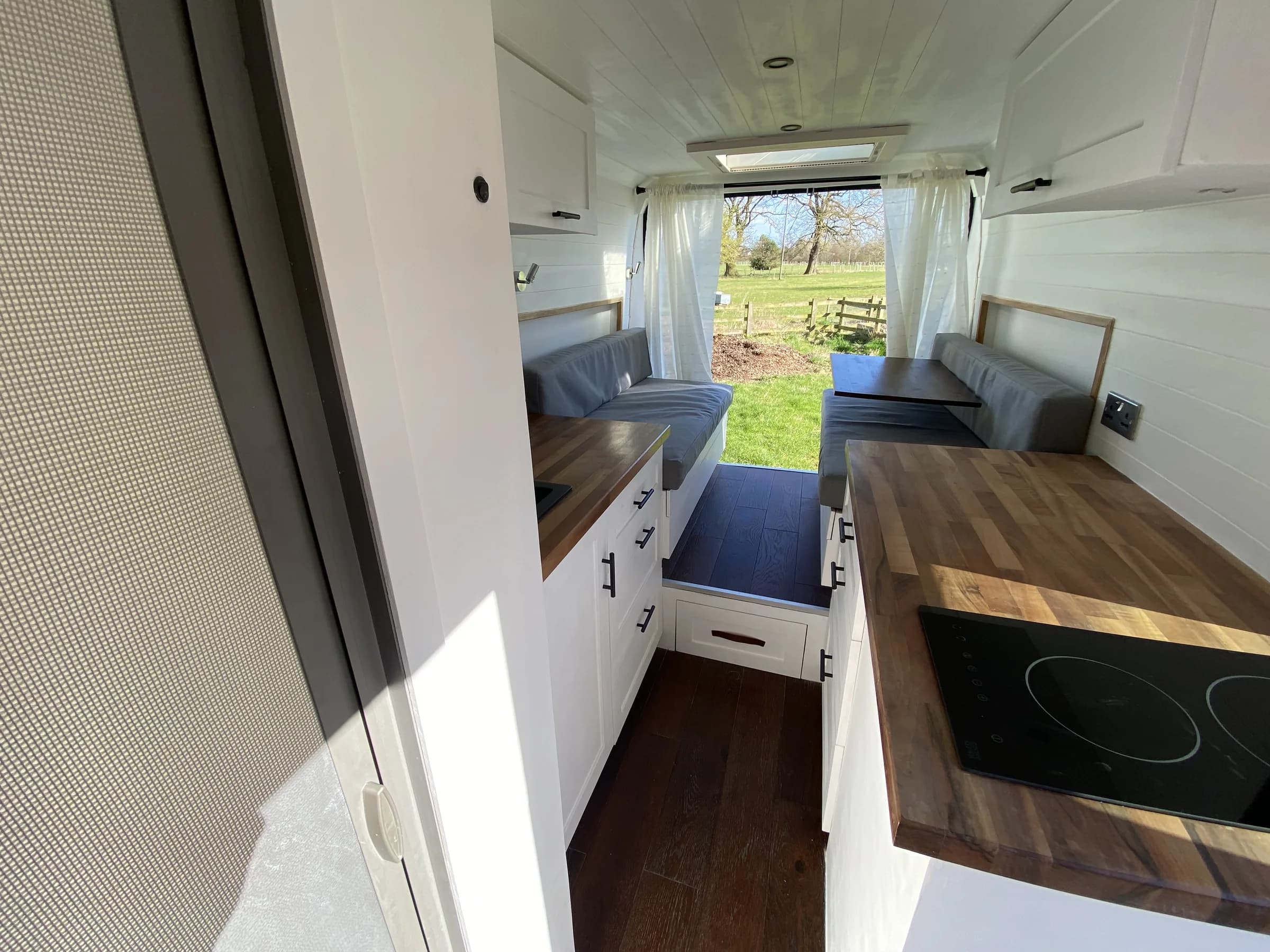 Campervan galley with an inset induction hob and usable worktop