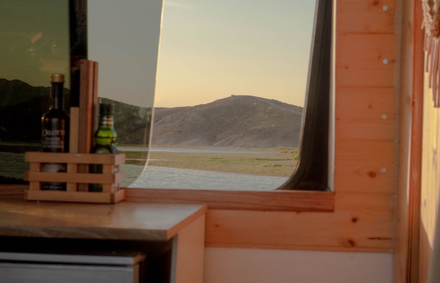 The view from a camper van toward a scenic sunset