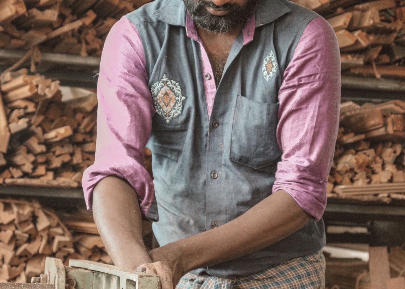 Craftsperson working with timber in a busy workshop