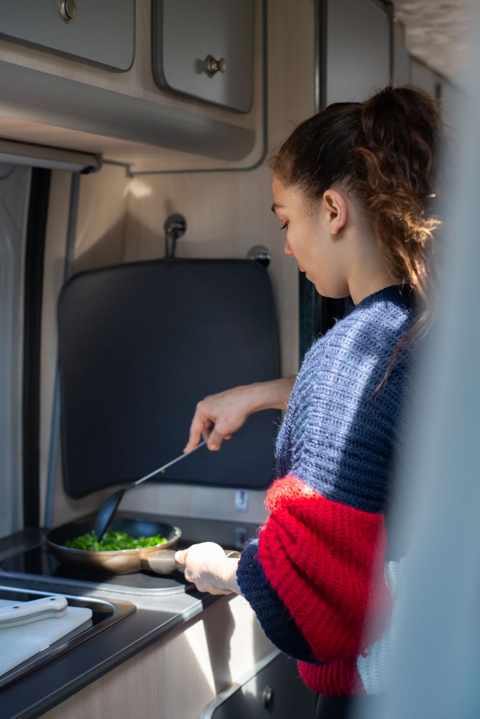 Cooking inside a campervan kitchen