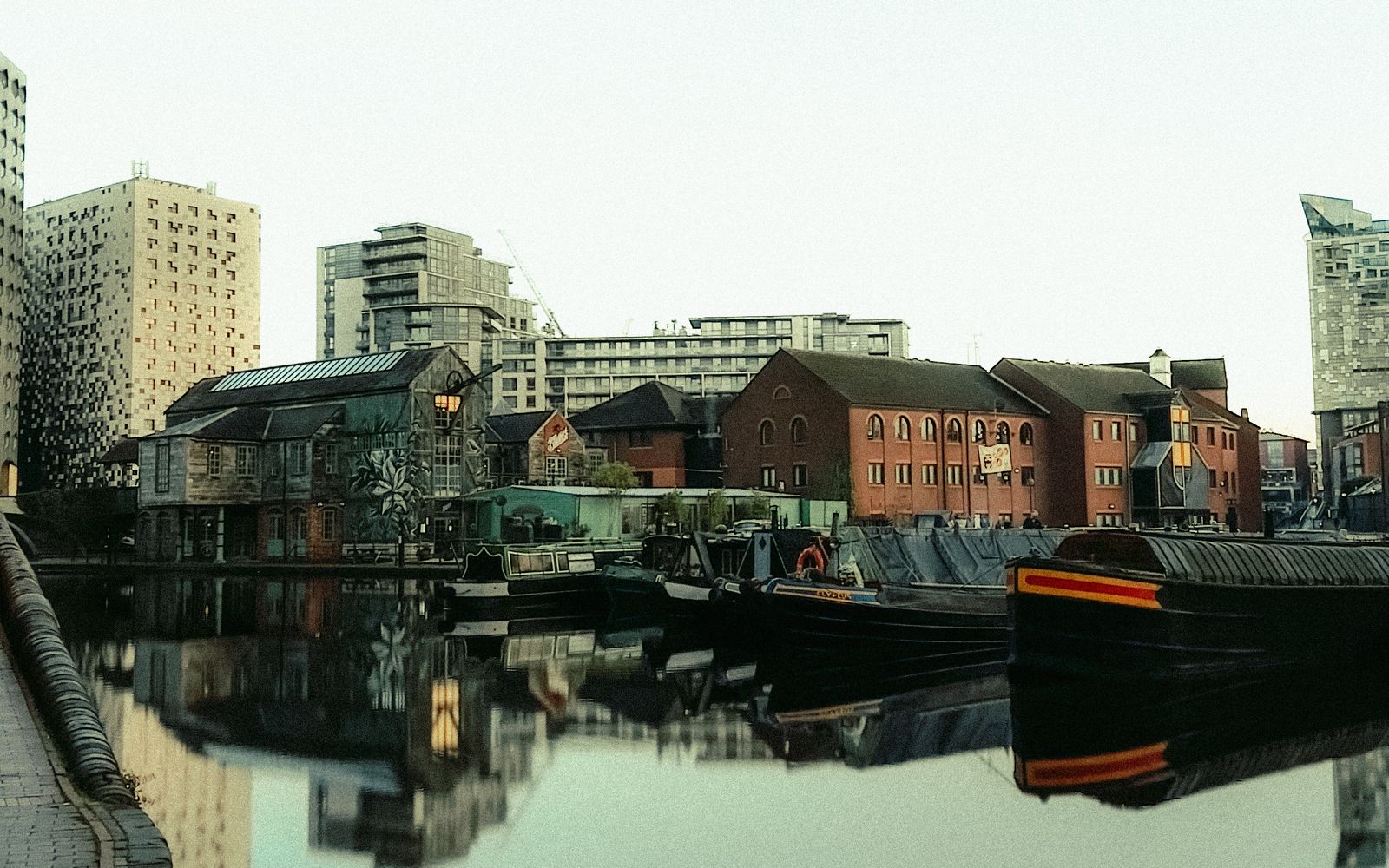 Canal boats and the Birmingham cityscape, England