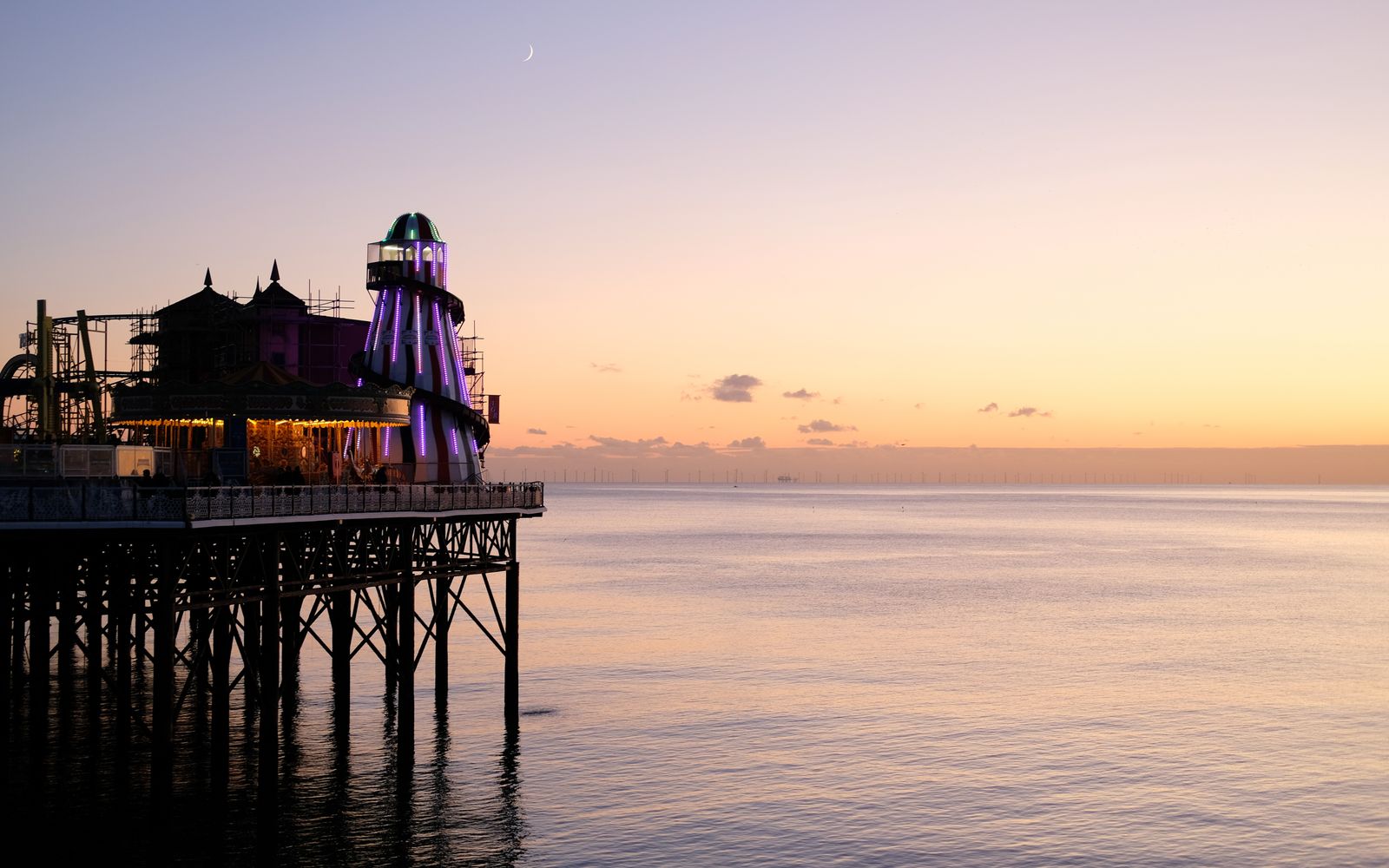Brighton Pier lit up at sunset