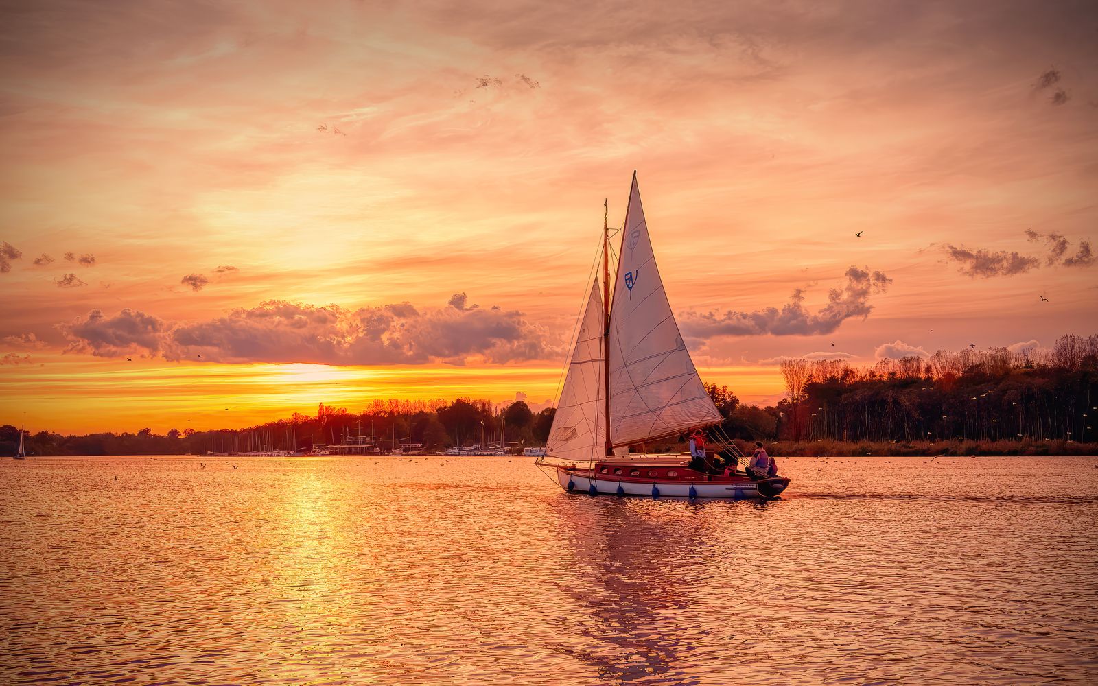 A sailboat at sunset on the Norfolk Broads near Norwich