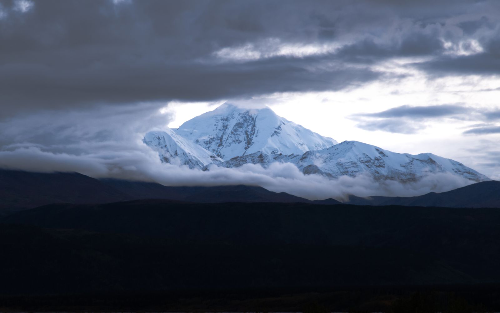 The snowcapped summit of Denali emerging from cloud, Alaska
