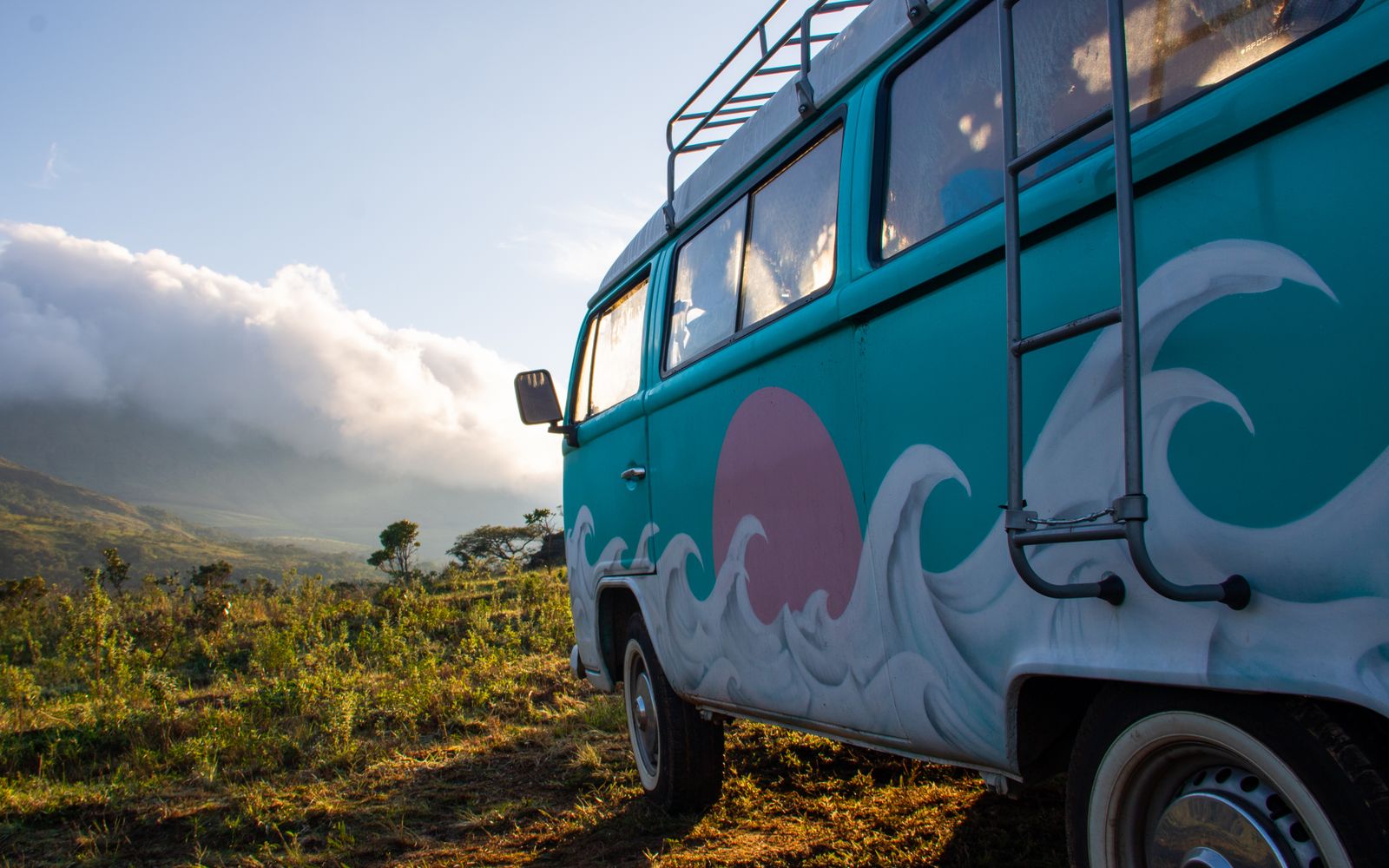 Vintage camper van in an open landscape at sunrise — Omaha